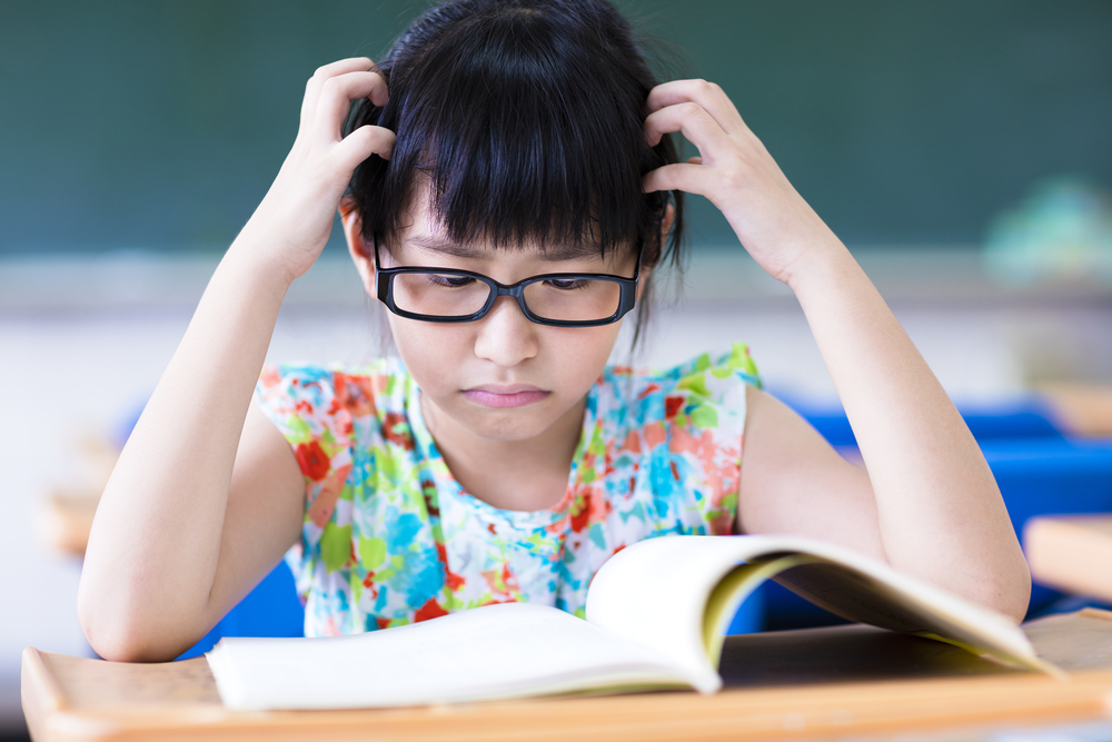 Girl upset reading books