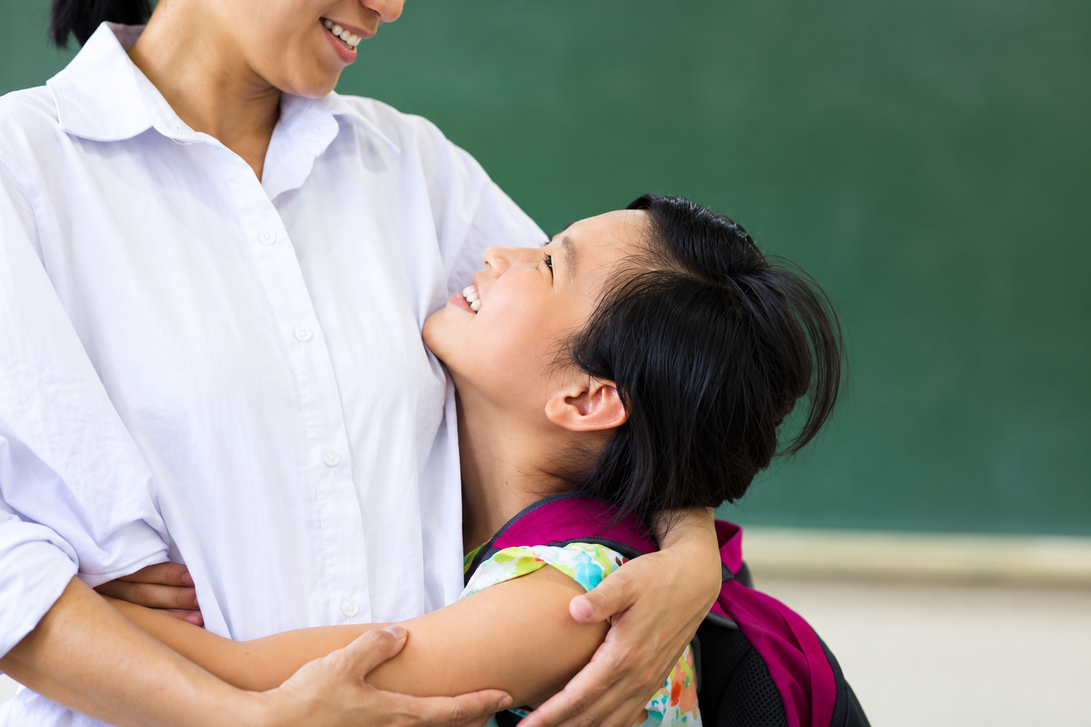 teacher hugging student