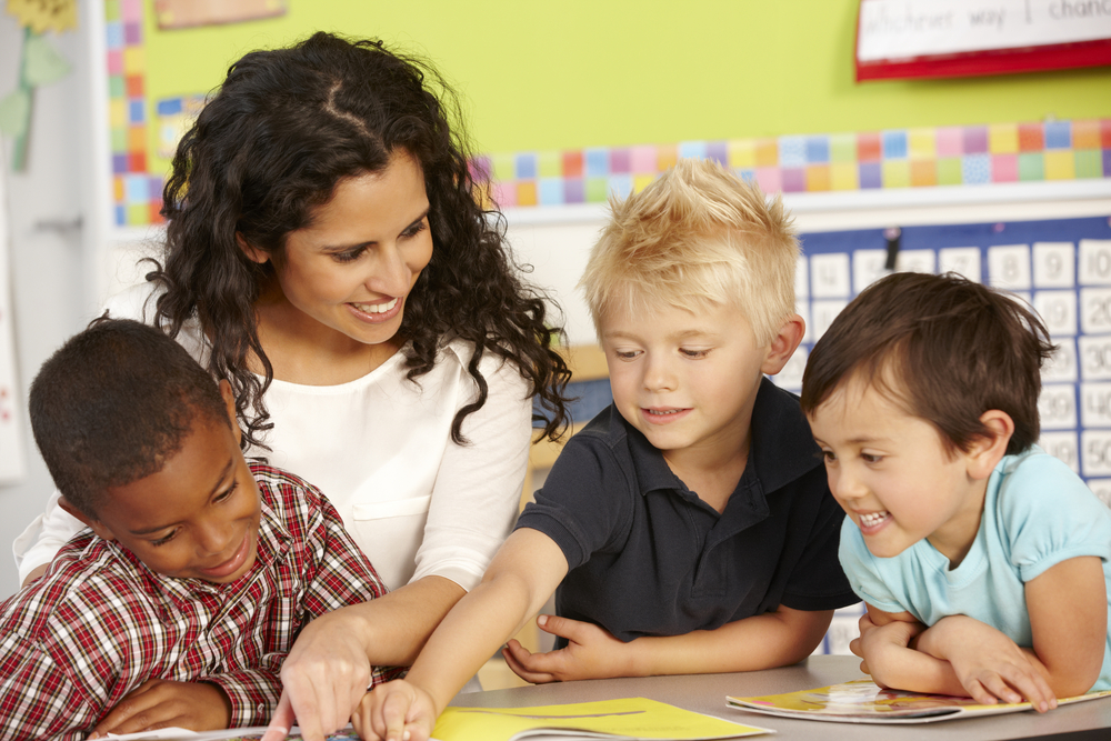 teacher teaching to small group of kids